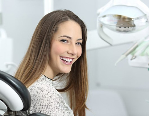 a person smiling before receiving cosmetic dentistry in Edison, NJ