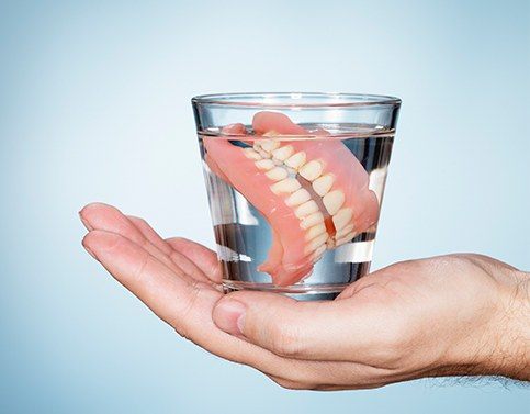 Full denture in a glass of water