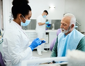 A dentist explaining the denture creatin process