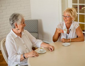 Ladies converse over coffee