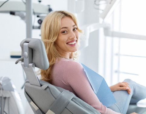 Woman smiling while sitting in treatment chair