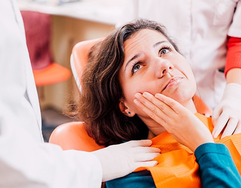 Woman with toothache visiting her Edison emergency dentist