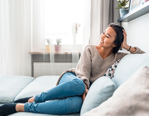 Woman smiling while relaxing at home