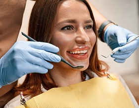 Woman with clear aligners smiling during dental visit